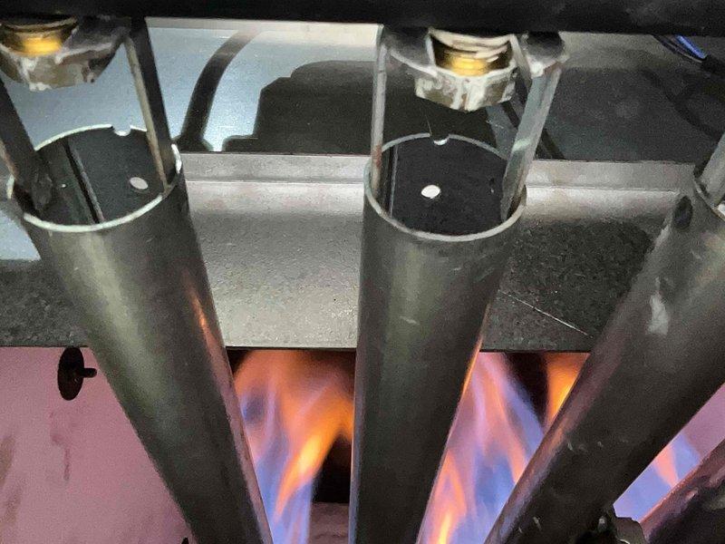 Performed routine maintenance on 3-year-old boiler system. Inspected heat exchanger and combustion chamber, confirming proper flame pattern with good blue coloration indicating complete combustion. Examined heat exchanger fins for dust accumulation and cleaned as necessary to maintain optimal heat transfer efficiency.