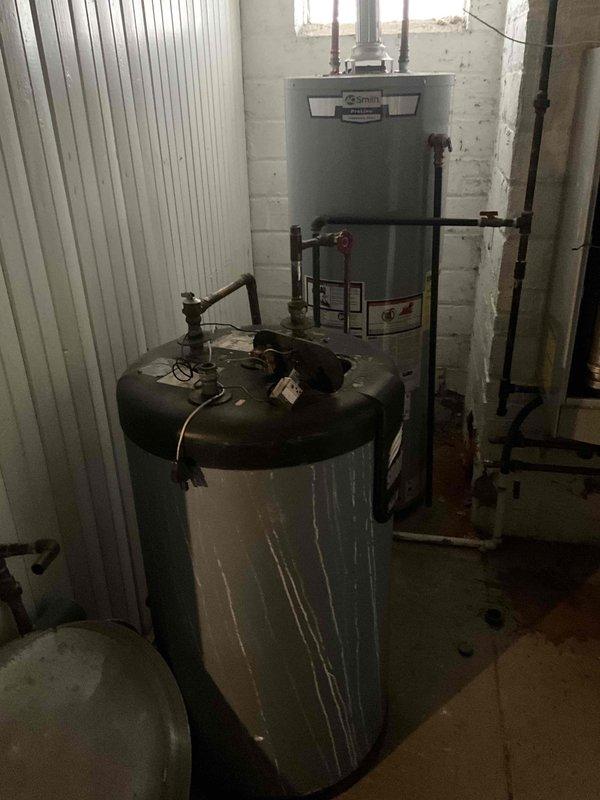 Completed installation of two combi boilers in basement utility room, replacing existing AO Smith water heating system. Installed new units with proper copper and galvanized steel piping connections, ensuring all intake/outflow valves and fittings were properly secured and operational.
