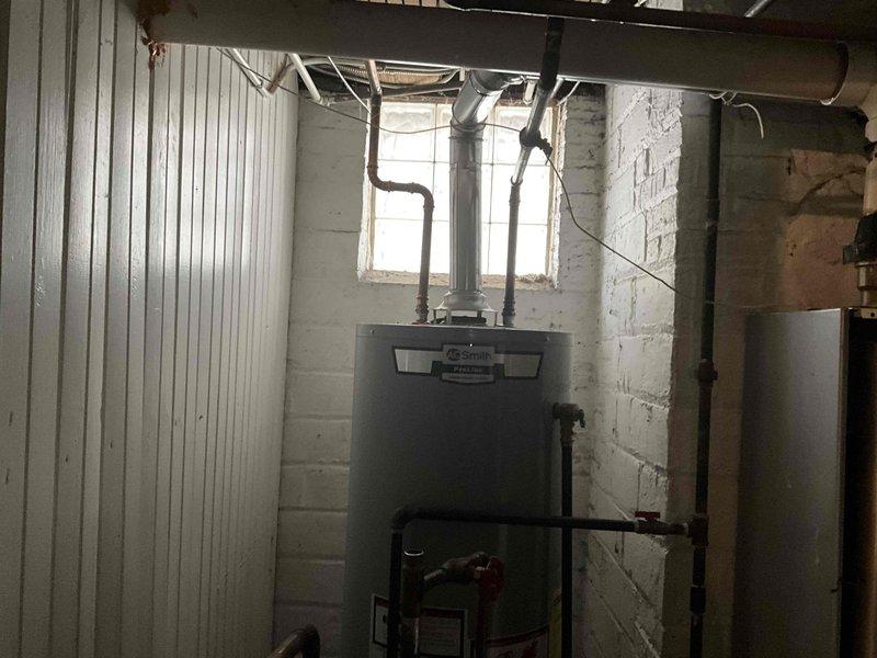 Completed installation of two combi boilers in basement utility room, replacing existing AO Smith water heating system. Installed new units with proper copper and galvanized steel piping connections, ensuring all intake/outflow valves and fittings were properly secured and operational.