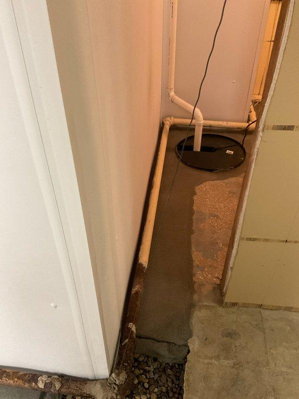 Responded to service call for intermittent boiler operation. Diagnosed leaking return pipe connection. Repaired pipe leak and verified proper system operation with heat set at 69°F. Documentation shows evidence of previous water damage on concrete floor near plumbing connections.