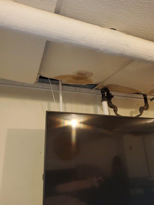 Responded to service call for 8-year-old boiler system with reported pipe leak. Inspection revealed significant water damage to ceiling with visible staining and deterioration directly below the boiler's supply lines. Located and repaired leaking pipe connection using friction tape after thoroughly documenting the damage with measurements and photographs for customer records.