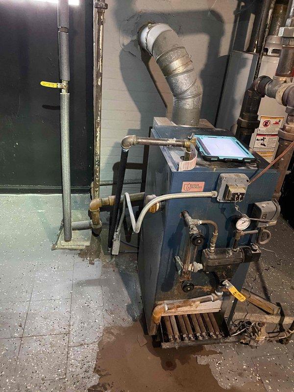 Responded to service call for previously serviced non-functioning boiler. Inspection revealed water contamination in the combustion chamber causing system failure. Drained system, cleaned affected components, and restored proper operation. Unit tested and confirmed working before departure.