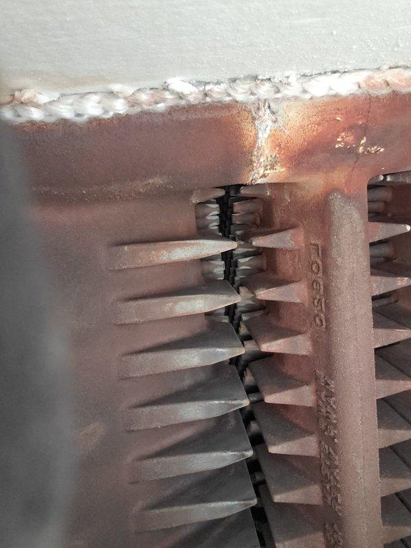 Performed maintenance service on 4-year-old steam boiler exhibiting surging issues. Observed frost accumulation on heat exchanger fins and signs of corrosion. Skimmed boiler to address water quality concerns and inspected burner assembly for proper operation. Customer renewed maintenance value plan.