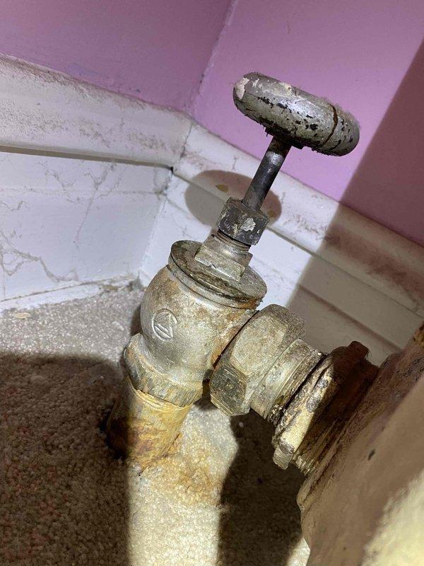 Responded to service call for radiator leak. Upon inspection, identified severely corroded water valve with significant mineral deposits and deterioration at connection points. Replaced aging valve assembly to resolve the leak and restore proper system operation.