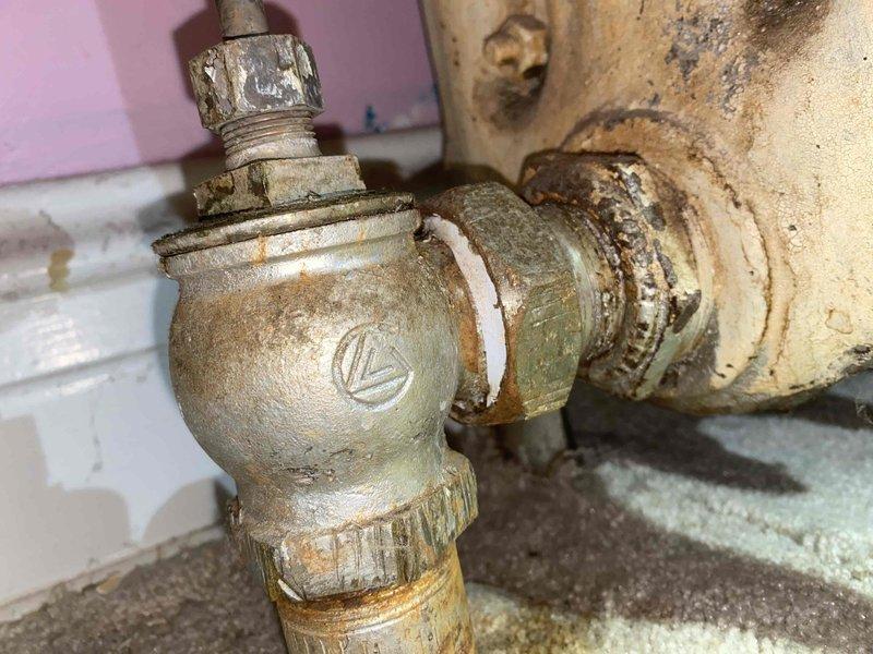 Responded to service call for radiator leak. Upon inspection, identified severely corroded water valve with significant mineral deposits and deterioration at connection points. Replaced aging valve assembly to resolve the leak and restore proper system operation.
