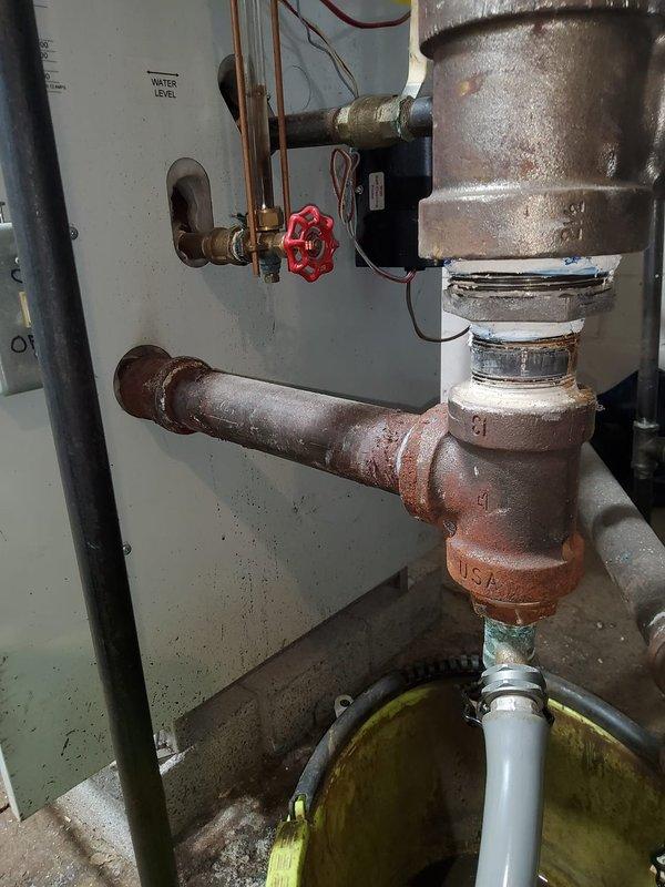 Completed installation of vents, water feeder, and low water cut-off on heating system. Properly connected copper piping with appropriate valves and verified water level control functionality. System now operating with proper safety controls in place.
