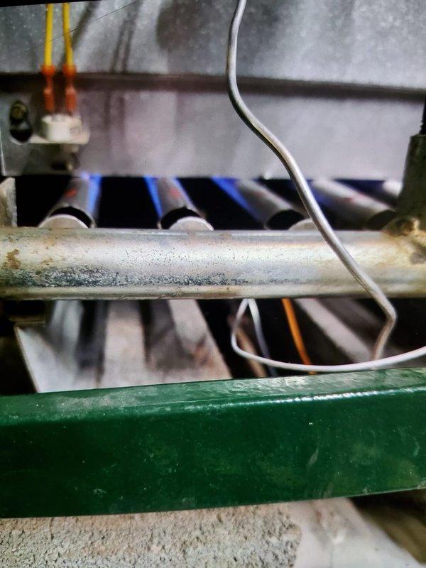 Performed annual tune-up on 2-year-old MVP steam boiler. Inspected burner assembly which showed normal blue flame pattern but early signs of corrosion on heat exchanger piping. Cleaned dust accumulation from heat exchanger fins and checked all connections. System is functioning properly but recommend monitoring corrosion development during next maintenance visit.