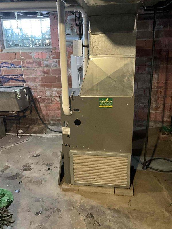 Performed furnace replacement estimate for customer experiencing no heat issue. Current unit located in basement with brick walls shows significant age. Replacement part is on back-order, with installation scheduled for January 28th. Comprehensive assessment completed with photo documentation of existing system and installation environment.