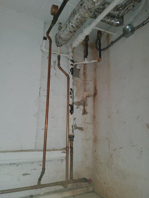 Responded to service call for no heat condition. Diagnosed significant water leaks from boiler system with extensive water damage visible on surrounding walls. Observed rust-colored staining and deterioration along copper and PVC piping connections, indicating ongoing moisture issues requiring immediate attention.
