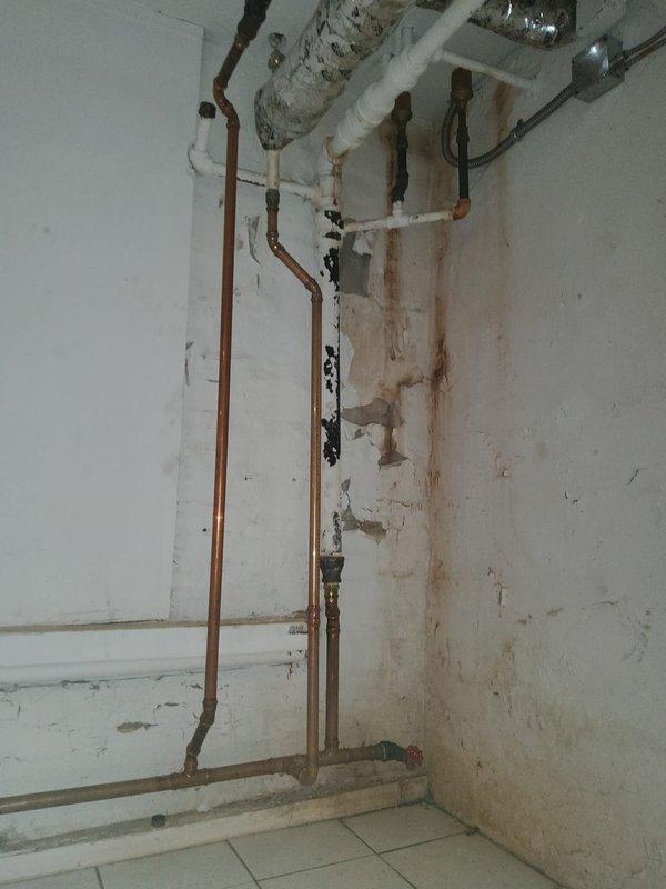 Responded to service call for no heat condition. Diagnosed significant water leaks from boiler system with extensive water damage visible on surrounding walls. Observed rust-colored staining and deterioration along copper and PVC piping connections, indicating ongoing moisture issues requiring immediate attention.