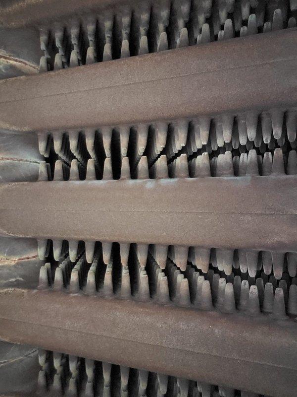 Performed scheduled boiler tune-up service that had been previously rescheduled. Inspected heat exchanger fins which showed normal dust accumulation and examined burner assembly which displayed proper blue flame pattern, indicating efficient combustion. System was confirmed operational with no performance issues detected.