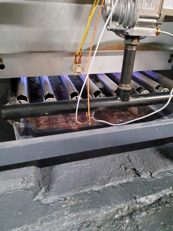 Performed scheduled boiler tune-up service that had been previously rescheduled. Inspected heat exchanger fins which showed normal dust accumulation and examined burner assembly which displayed proper blue flame pattern, indicating efficient combustion. System was confirmed operational with no performance issues detected.