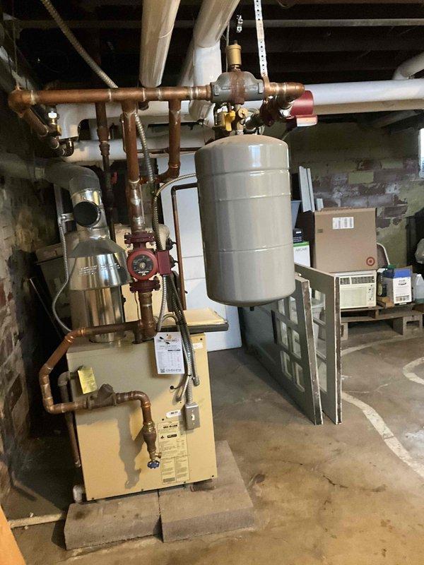 Conducted assessment of existing boiler system to provide estimate for pipe rework. Inspection revealed extensive copper piping network with expansion tank and multiple circulation pumps requiring modification. Documented current configuration including PVC lines and connection points to develop comprehensive replacement plan.