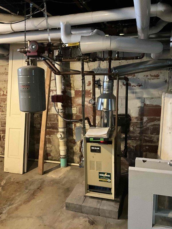 Conducted assessment of existing boiler system to provide estimate for pipe rework. Inspection revealed extensive copper piping network with expansion tank and multiple circulation pumps requiring modification. Documented current configuration including PVC lines and connection points to develop comprehensive replacement plan.