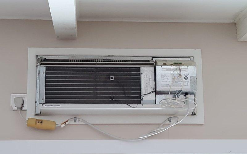 Responded to service call for non-operational furnace. Upon inspection, found wall-mounted mini-split AC system with possible electrical issues evidenced by discoloration around the outlet. Documented condition with photos for further assessment.
