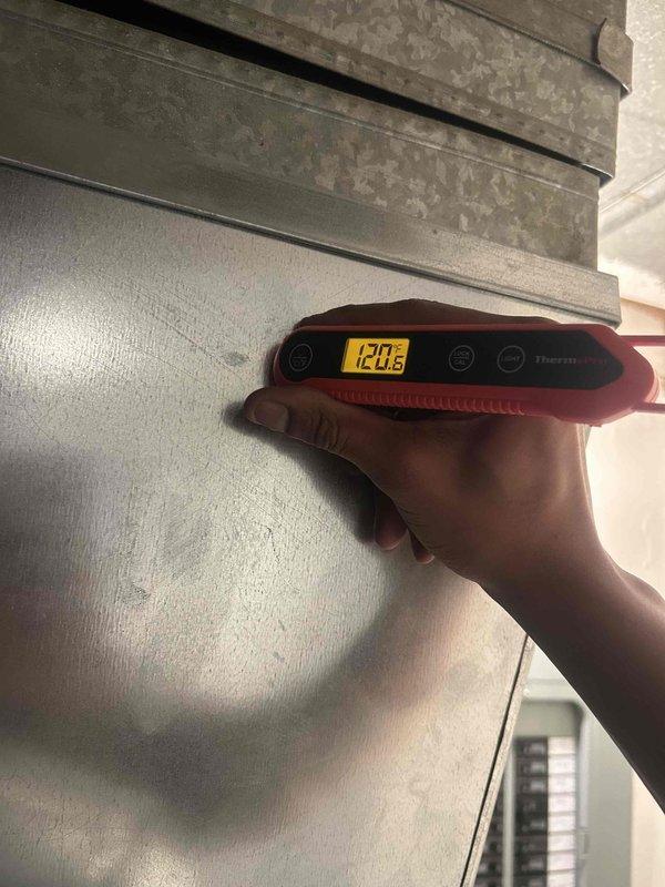 Performed scheduled heating tune-up on residential furnace system. Removed front panel to inspect internal components including circuit boards, wiring, and control mechanisms. Temperature readings taken with digital thermometer showed 120.2°F at the supply ductwork, confirming proper heating operation.