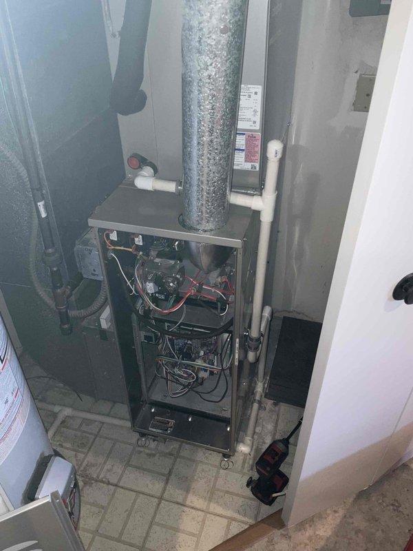 Performed scheduled heating tune-up on residential furnace system. Removed front panel to inspect internal components including circuit boards, wiring, and control mechanisms. Temperature readings taken with digital thermometer showed 120.2°F at the supply ductwork, confirming proper heating operation.