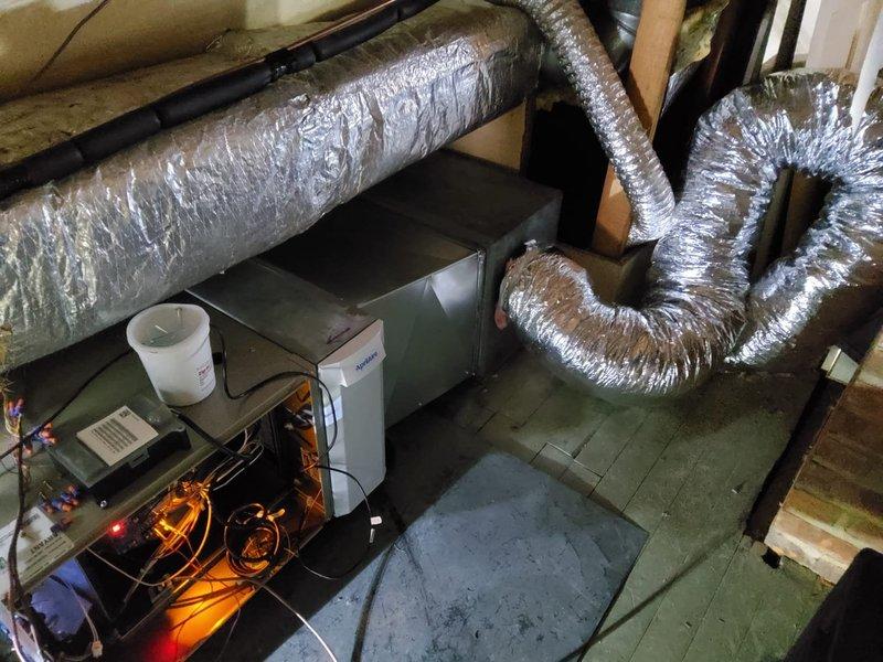 Completed warranty replacement of air handler with new gas furnace and evaporator coil. Integrated the new furnace with existing heat pump system, configuring it to function as auxiliary heat source. Installation included proper connection of ductwork, electrical components, and control systems in utility area.