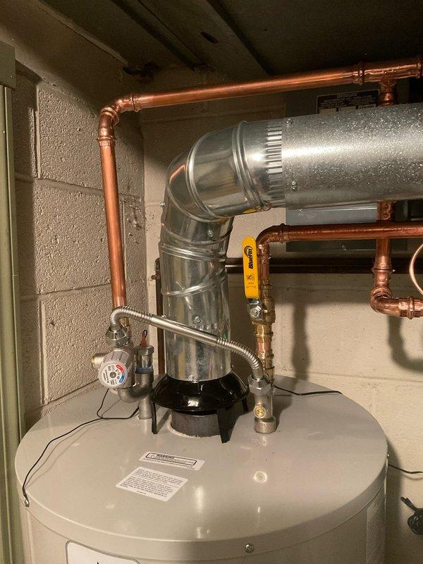 Completed installation of dual 50-gallon, 50K BTU water heater system with two T-5 expansion tanks, drain pans, and 1" water lines. Installation included isolation valves for expansion tanks, anode rods, mixing valves, and a standard air purge. All copper piping connections were properly fitted with appropriate shut-off valves, and the ventilation system was installed with galvanized steel ductwork.