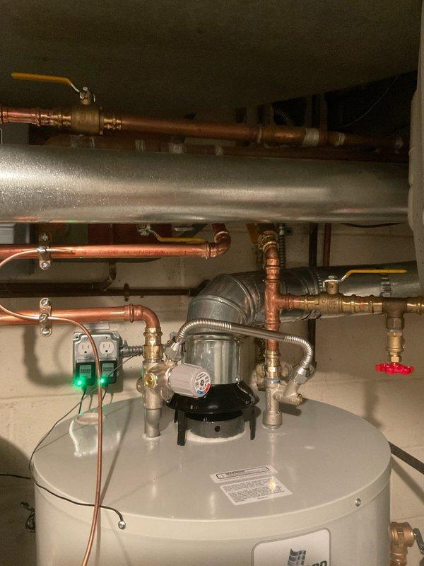 Completed installation of dual 50-gallon, 50K BTU water heater system with two T-5 expansion tanks, drain pans, and 1" water lines. Installation included isolation valves for expansion tanks, anode rods, mixing valves, and a standard air purge. All copper piping connections were properly fitted with appropriate shut-off valves, and the ventilation system was installed with galvanized steel ductwork.