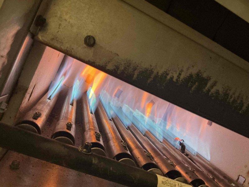 Performed annual tune-up service on two boiler systems. Conducted thorough combustion analysis with C161 analyzer confirming proper oxygen levels (21.0%) and verified zero carbon monoxide emissions. Inspected burner assembly showing normal flame pattern with characteristic blue base and orange tips, indicating efficient gas combustion with no concerning deposits or obstructions.