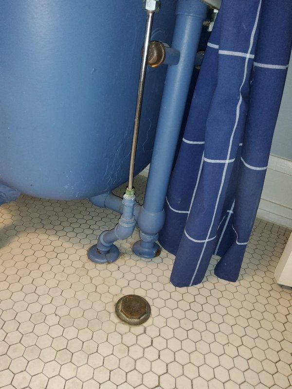 Accessed bathroom plumbing system by opening wall adjacent to toilet to expose leaking 2" cast iron pipe. Removed damaged section and replaced with new PVC piping, ensuring proper connections and sealing. Completed functional testing to verify repair eliminated the leak.