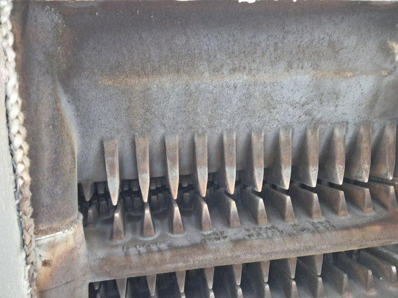 Performed annual heating system inspection and identified significant accumulation of dust, rust, and oxidation on heat exchanger fins. Documented extensive discoloration and wear on the metal components with visible evidence of moisture exposure. System requires thorough cleaning and assessment for proper heat transfer efficiency.