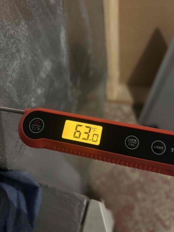 Performed standard furnace maintenance which revealed a severely clogged air filter with significant dust and debris accumulation, restricting proper airflow. Replaced the contaminated filter and verified system operation with temperature readings (63.6°F), restoring optimal system efficiency and preventing potential airflow restrictions.