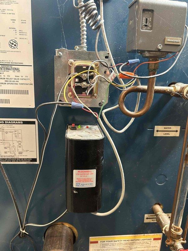 Responded to service call for 10-year-old residential boiler with automatic shutoff malfunction. Diagnosed and repaired site gauge issue affecting water level monitoring system. Inspected heat exchanger tubes and burner assembly, noting normal wear consistent with unit age.