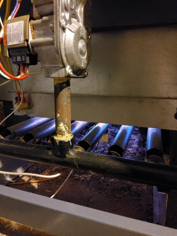 Responded to service call for non-operational boiler approximately 5-10 years old. Inspection revealed gas valve assembly functioning properly with good flame pattern across burners, though brass gas line shows signs of oxidation. Verified proper gas flow and combustion, restored system to working order.