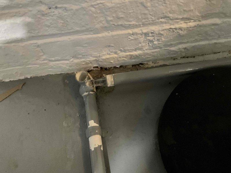 Responded to no-heat service call for a 20-year-old furnace system. Upon inspection, discovered deteriorated PVC condensate drainage with visible leakage and wall penetration damage. Recommended complete system replacement due to age and condition of equipment, with attention to proper drainage installation and sealing to prevent future moisture issues.