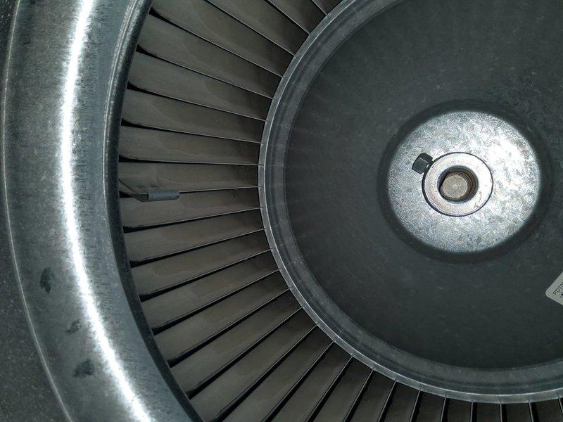 Performed scheduled maintenance on customer's heating system. Inspected blower wheel assembly and motor components, checking electrical connections and verifying proper operation of ignition system (blue flame indicators observed). System was returned to service in good working condition.