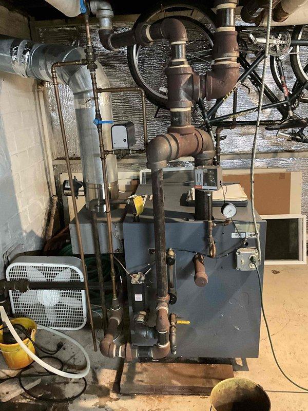 Conducted comprehensive inspection of aging steam boiler system showing significant pipe corrosion and wear. Evaluated existing installation in basement mechanical room, noting multiple deteriorated copper pipes, valves and fittings throughout the distribution network. Provided replacement estimate for complete system upgrade to address efficiency concerns and prevent potential failure risks.