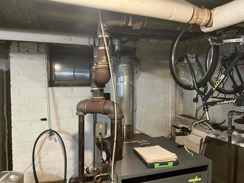 Conducted comprehensive inspection of aging steam boiler system showing significant pipe corrosion and wear. Evaluated existing installation in basement mechanical room, noting multiple deteriorated copper pipes, valves and fittings throughout the distribution network. Provided replacement estimate for complete system upgrade to address efficiency concerns and prevent potential failure risks.