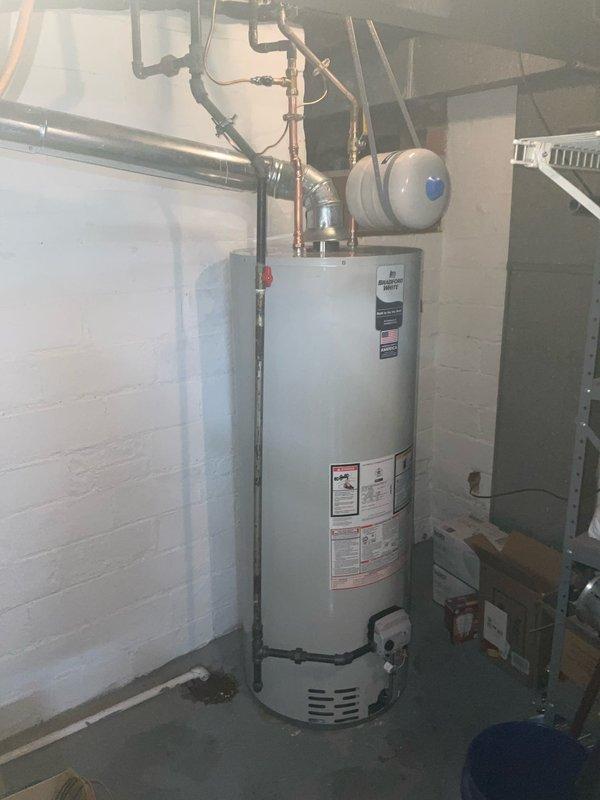 Installed new water heater with proper bonding of water lines to meet code requirements. Completed installation includes expansion tank and ICON System control unit. All connections verified and system functioning correctly.