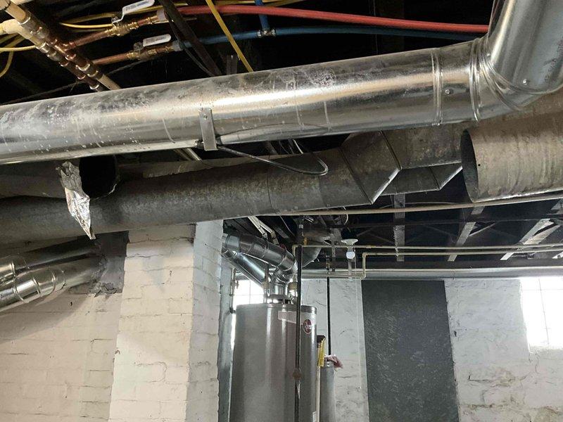 Inspected fallen ductwork in basement utility area and assessed damage to main supply trunk lines. Found deteriorated insulation with multiple tears exposing metal ducting. Provided estimate for reconnecting and securing the ductwork system, including installation of additional common return for upstairs zone to improve system efficiency.