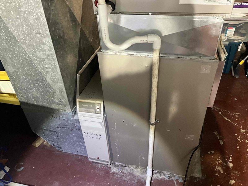Performed diagnostic assessment of 15-year-old furnace system showing significant deterioration. Inspection revealed worn ductwork connections and aging control components including Honeywell thermostat panel. Recommended full system replacement due to unit age, declining efficiency, and potential safety concerns.