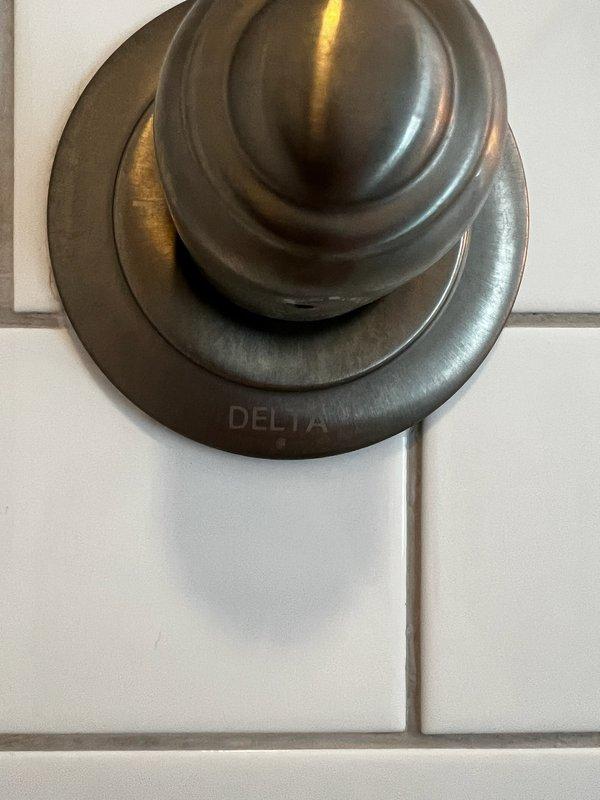 Replaced defective hot water handle mechanism on Delta shower fixture in 150-year-old home. Restored proper functionality to shower control system. All components now operating correctly with no leaks observed.