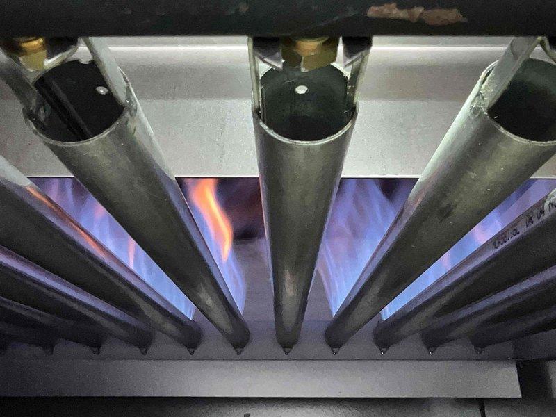 Performed scheduled boiler tune-up service. Inspected heat exchanger fins and burner assembly, confirming proper flame pattern with characteristic blue color indicating efficient combustion. All components were found to be in functional working condition.