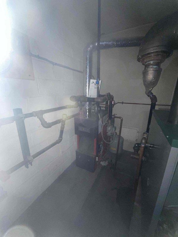 Performed annual maintenance inspection on 1-year-old boiler system. Examined backflow preventer, pressure regulator valve, and all copper pipe connections for proper function and signs of leakage. Inspected boiler unit, flue pipe, and PVC venting system, confirming all components are in good working order with no visible issues.