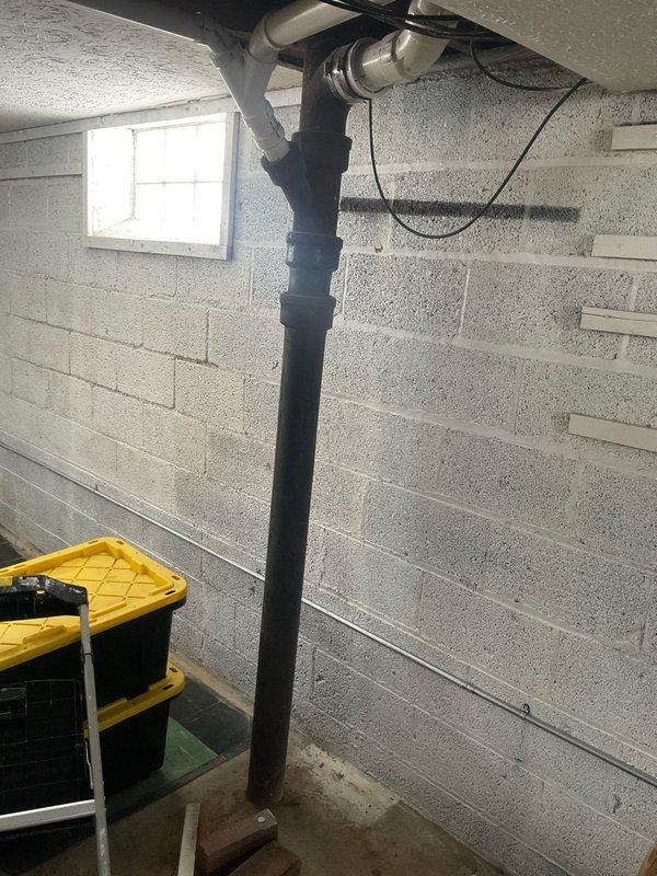 Conducted comprehensive plumbing assessment of aging copper supply line system showing significant oxidation and corrosion, particularly at joints and connection points. Inspection also revealed vertical waste stack with multiple connections in basement area requiring attention. Documented condition of plumbing infrastructure with photographs for future reference and potential remediation planning.