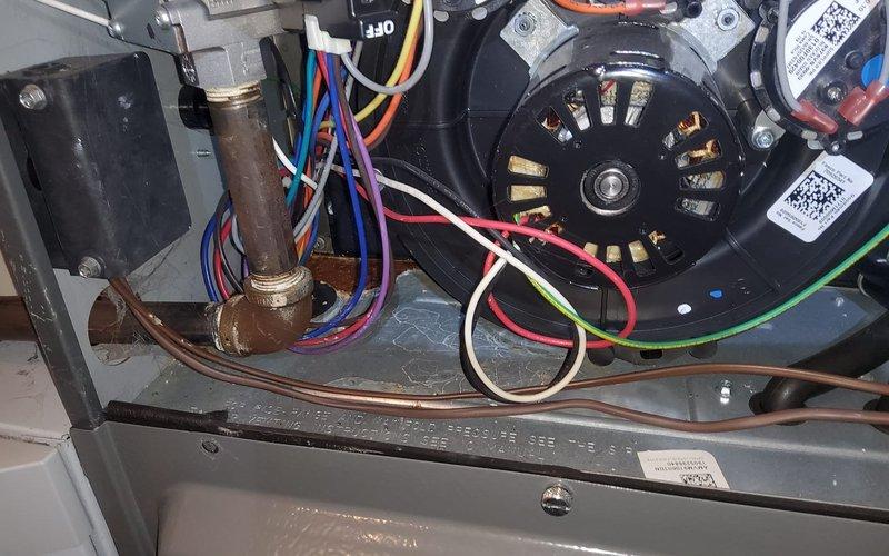 Performed routine maintenance on 8-year-old gas furnace, inspecting electrical connections and components including motor, fan assembly, and control wiring. Noted minor water leak from condensate drain line and advised customer to contact for service if condition worsens.