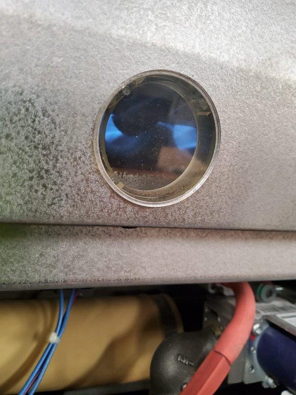 Performed routine maintenance on 16-year-old and 10-year-old heating furnaces per home plan agreement. Inspected flame sensor and sight glass for proper burner operation, confirming normal blue flame pattern. Checked and verified proper operation of ignition system and control board connections.
