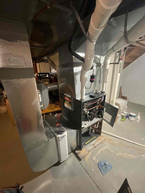 Performed annual maintenance on basement-installed furnace system. Conducted electrical safety check with multimeter showing 2.63 amp draw on equipment, within normal parameters. Inspected ventilation system including PVC piping and connections, confirming proper installation and functionality.