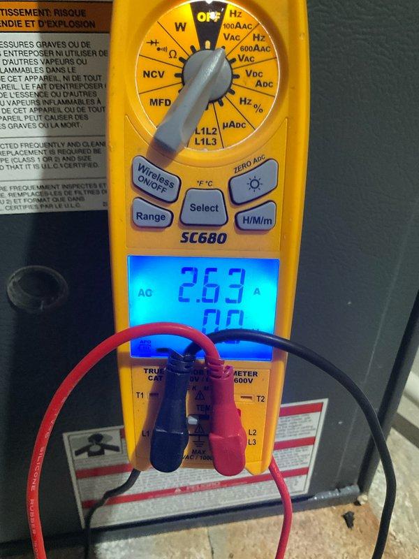 Performed annual maintenance on basement-installed furnace system. Conducted electrical safety check with multimeter showing 2.63 amp draw on equipment, within normal parameters. Inspected ventilation system including PVC piping and connections, confirming proper installation and functionality.