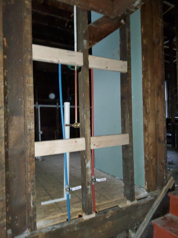 Completed stack replacement in interior wall cavity per estimate. Installed new vertical PVC drainage pipes with proper fittings, connecting to existing copper lines at base. Work included opening wall access, removing old stack, installing new components, and preparing area for subsequent drywall installation.