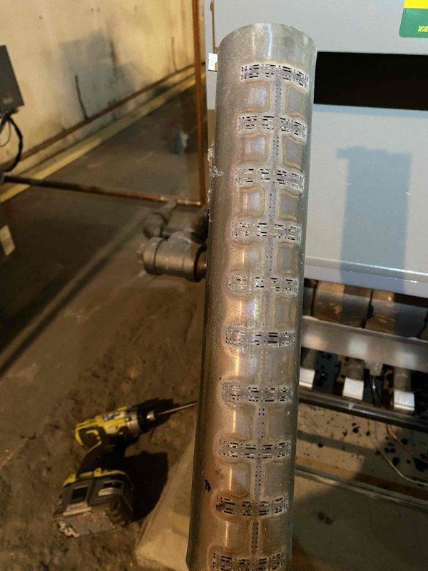 Responded to no-heat call for aging system (10+ years). Discovered severe corrosion and deterioration on critical pipe section that compromised system integrity. Removed damaged component, installed new replacement part, and verified proper system operation after repair.