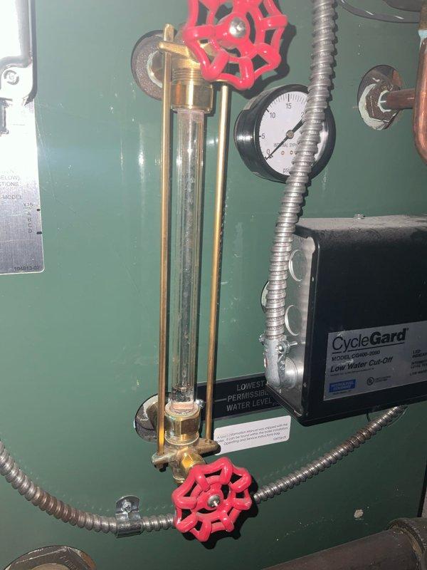 Performed scheduled heating tune-up on system. Inspected water level indicator and pressure gauge on boiler, noting normal operation with pressure reading within acceptable range. Examined CycleGard low water cut-off functionality and checked condition of aging valve assembly, which shows signs of corrosion but remains functional.