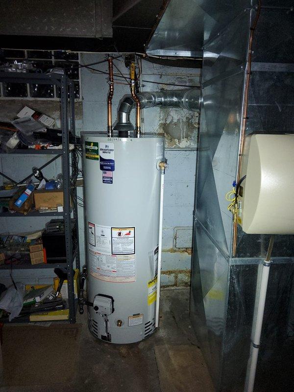 Replaced leaking water heater in 90-year-old home. Installed new copper supply lines with proper wall mounting and connected existing ventilation system to new unit. Old unit was leaking from both top and bottom connections after approximately 5 years of service.