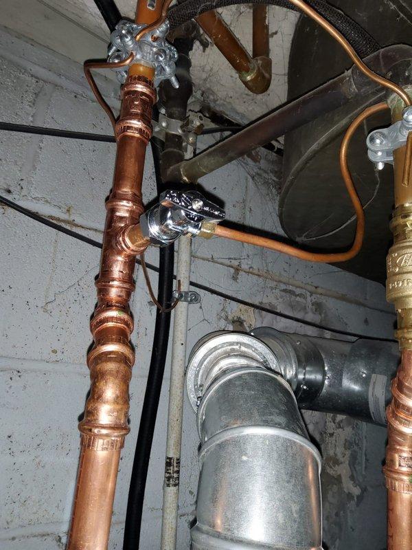 Replaced leaking water heater in 90-year-old home. Installed new copper supply lines with proper wall mounting and connected existing ventilation system to new unit. Old unit was leaking from both top and bottom connections after approximately 5 years of service.